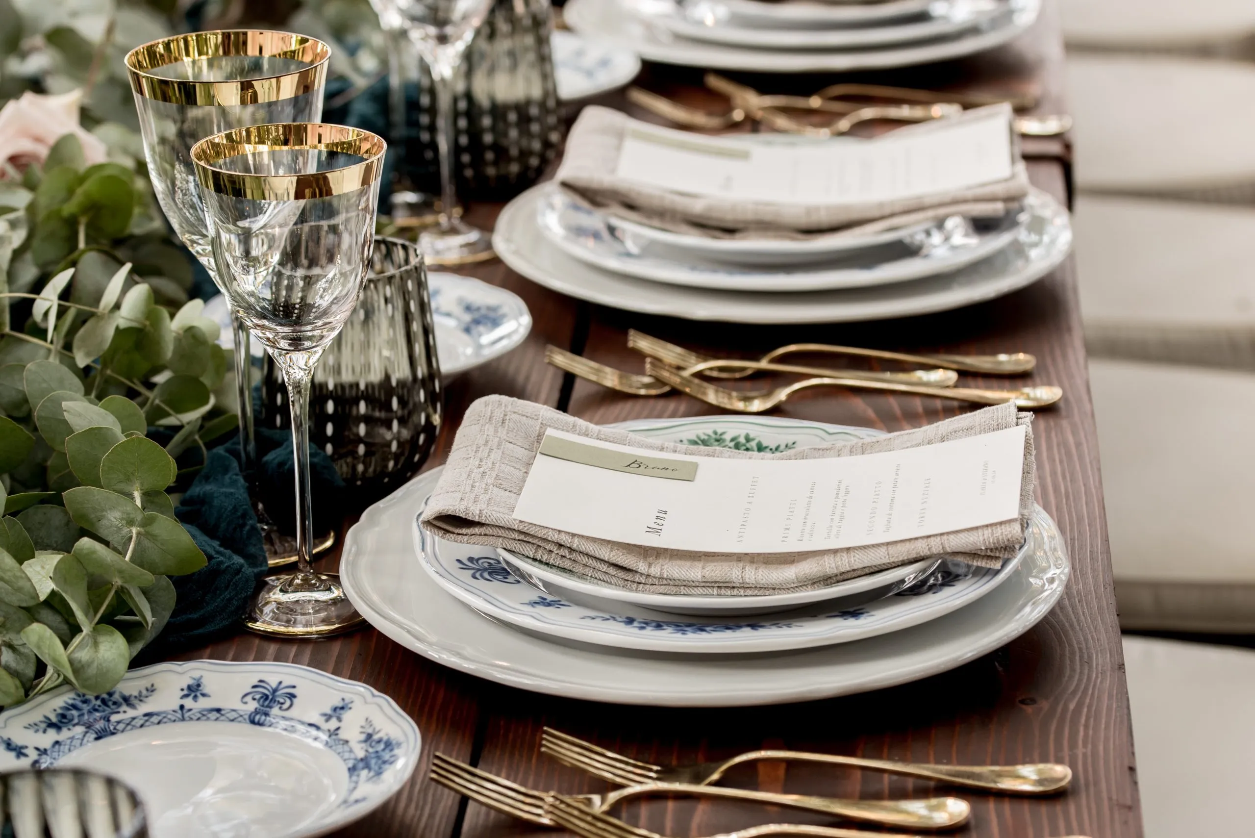 Formal dinnerware lined up on a table for wedding